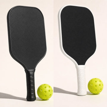 Carbon pickleball paddle with a black edge next to one with a white edge