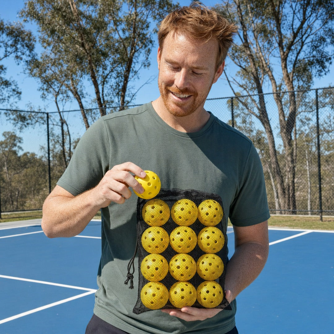 Dinkwell Outdoor Pickleballs 12-pack - h01 holding